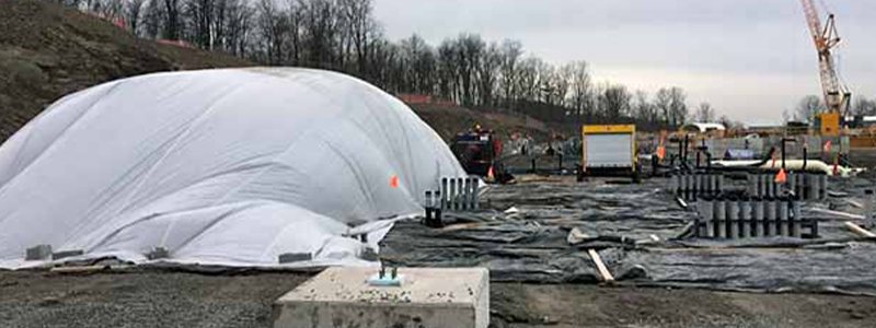 heaters being used to heat a large construction site in the winter
