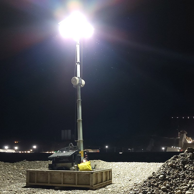 A light tower surrounded by gravel
